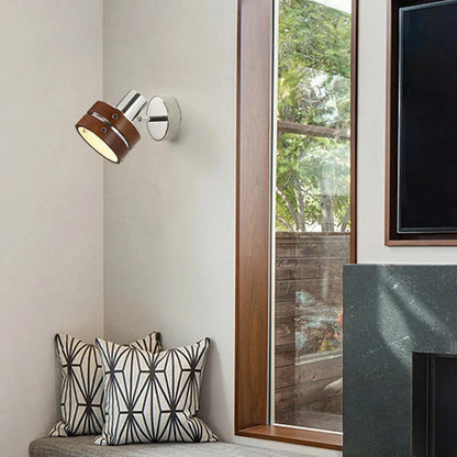 Adjustable wall spotlight in chrome and brown in a reading corner