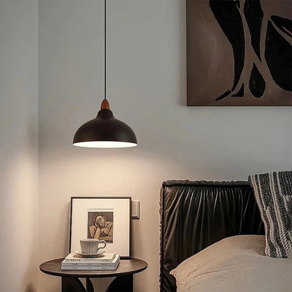 Black dome pendant light in a bedroom