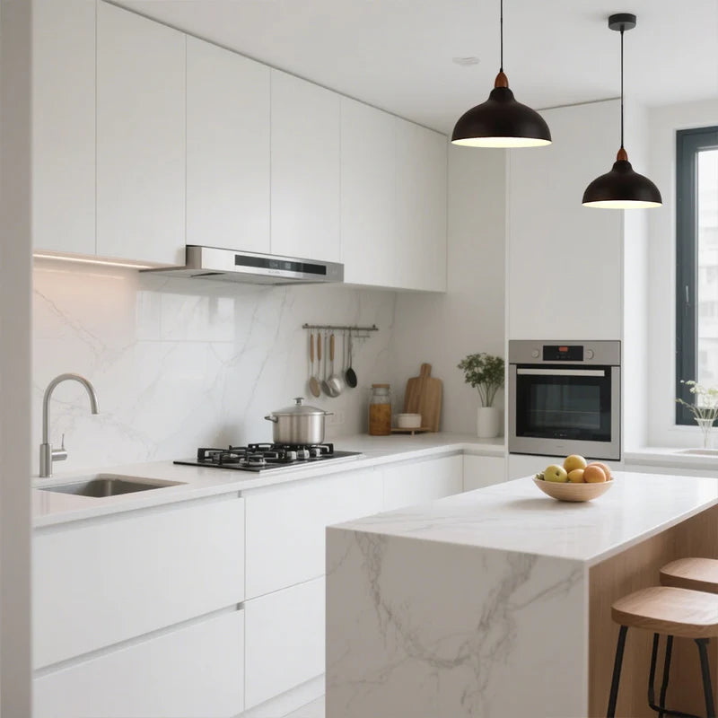 Black dome pendant lights over a kitchen island