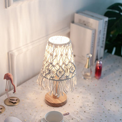 Boho macramé table lamp glowing beside books