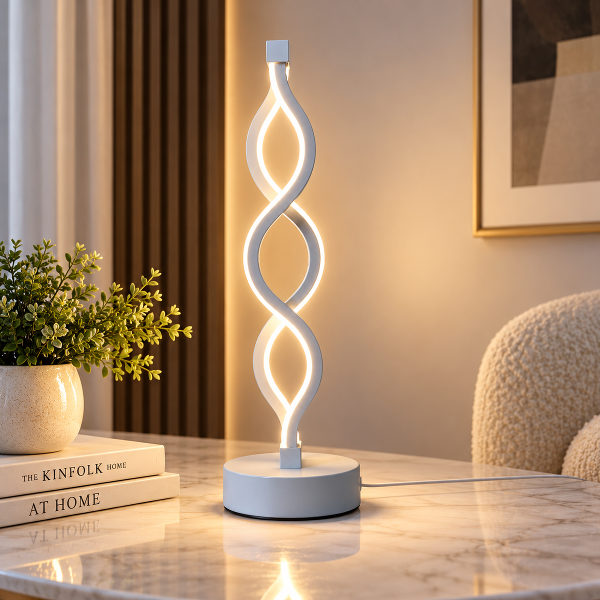 Silver spiral LED table lamp on a side table